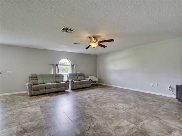 unfurnished living room with a textured ceiling and ceiling fan