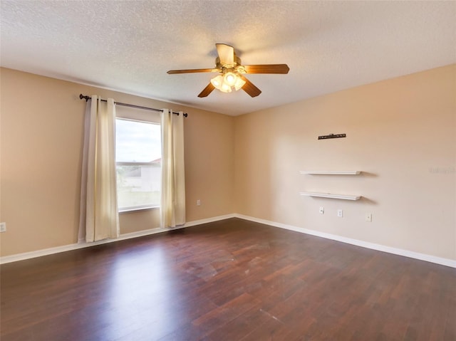 spare room with ceiling fan, dark hardwood / wood-style flooring, and a textured ceiling