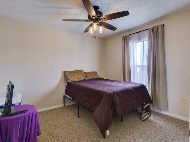 bedroom featuring ceiling fan, light colored carpet, and a textured ceiling