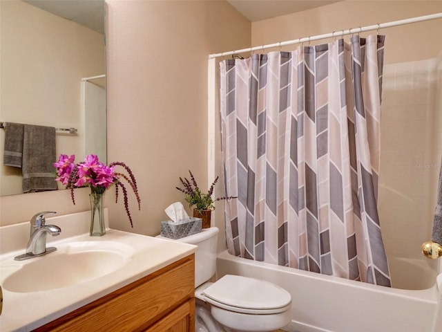 full bathroom with shower / tub combo with curtain, vanity, and toilet