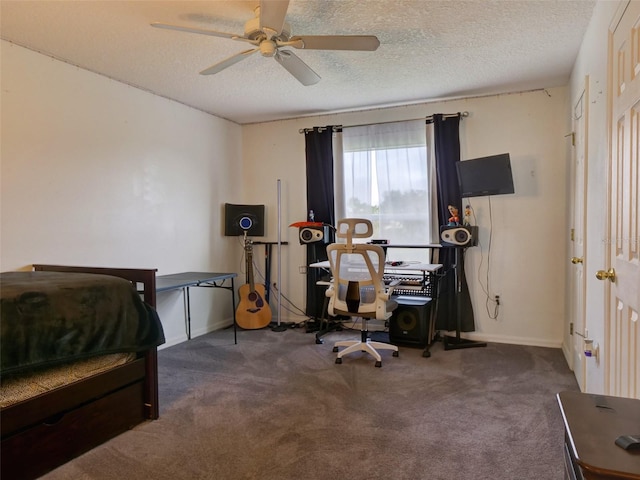 interior space featuring a textured ceiling, dark carpet, and ceiling fan