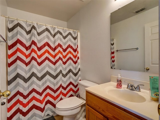 bathroom with vanity, curtained shower, and toilet