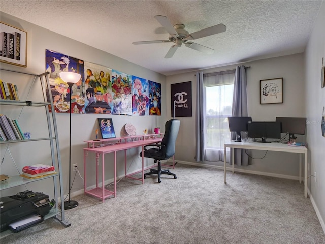 home office featuring ceiling fan, light colored carpet, and a textured ceiling