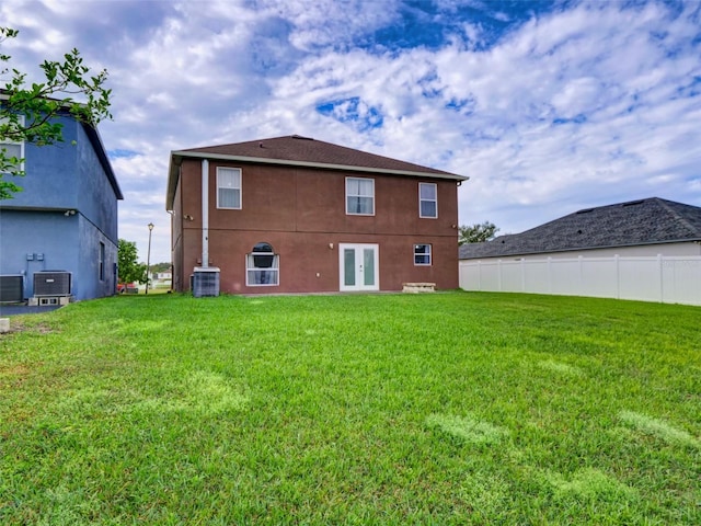 back of property featuring a yard, french doors, and central AC unit