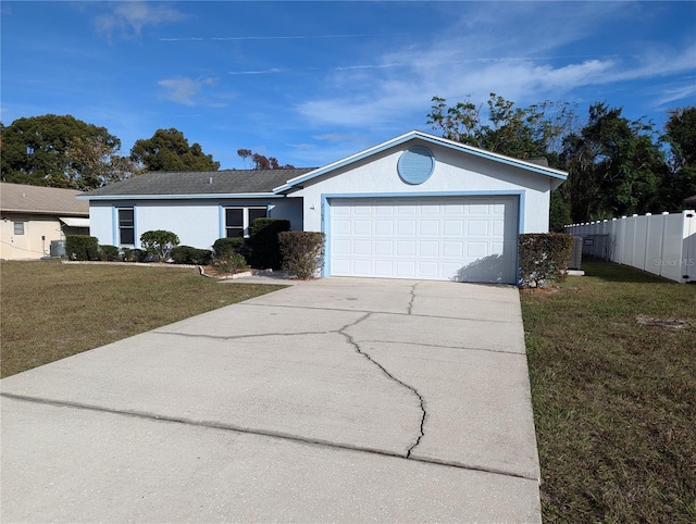 ranch-style house featuring a garage and a front lawn