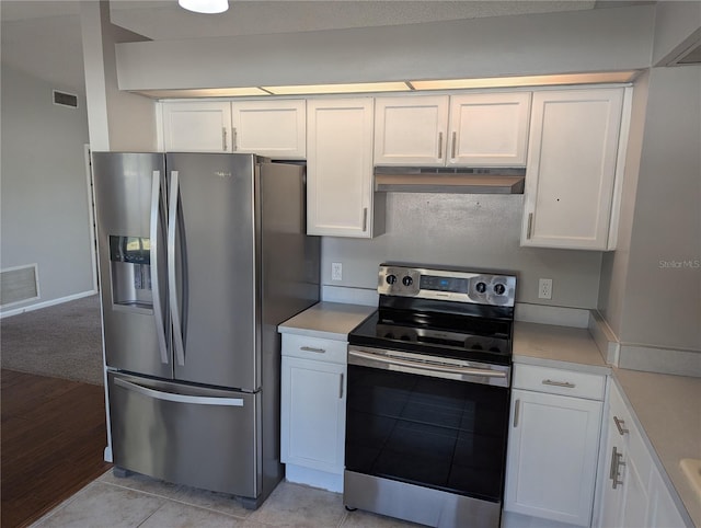 kitchen featuring white cabinetry, light tile patterned floors, and appliances with stainless steel finishes