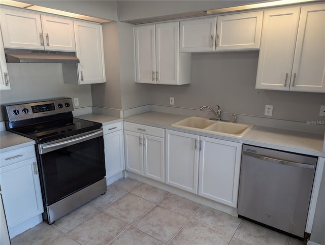 kitchen with white cabinets, sink, light tile patterned floors, and stainless steel appliances