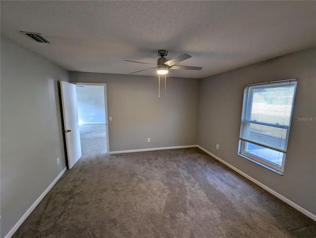 spare room with carpet flooring, ceiling fan, and a textured ceiling