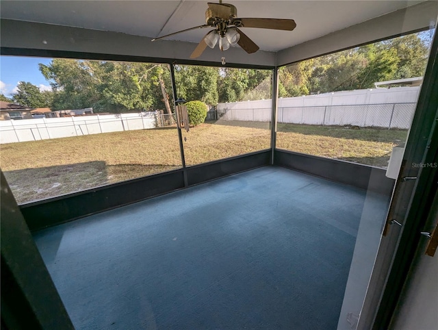 unfurnished sunroom with ceiling fan and a healthy amount of sunlight