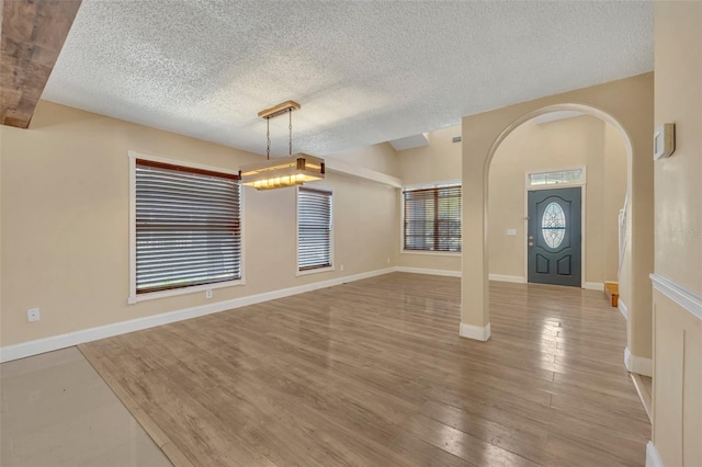 foyer featuring light hardwood / wood-style floors and a textured ceiling