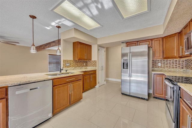 kitchen with ceiling fan, light stone countertops, tasteful backsplash, decorative light fixtures, and stainless steel appliances