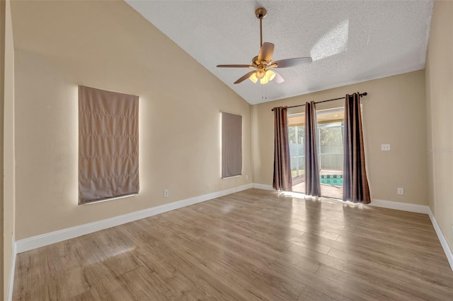 unfurnished room with a textured ceiling, high vaulted ceiling, light hardwood / wood-style flooring, and ceiling fan