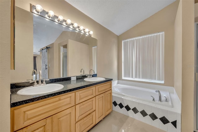 bathroom with tile patterned floors, separate shower and tub, lofted ceiling, a textured ceiling, and vanity