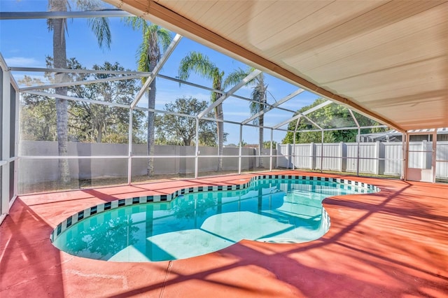 view of pool featuring glass enclosure and a patio area