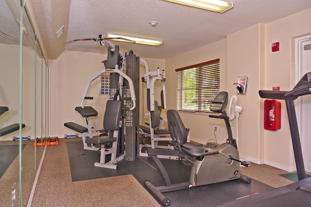 workout room with a textured ceiling