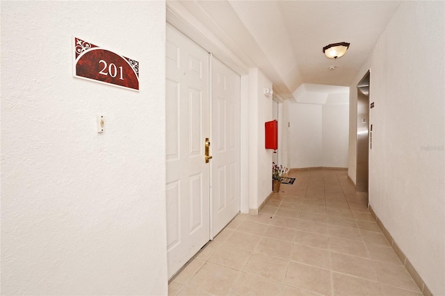 corridor with light tile patterned flooring