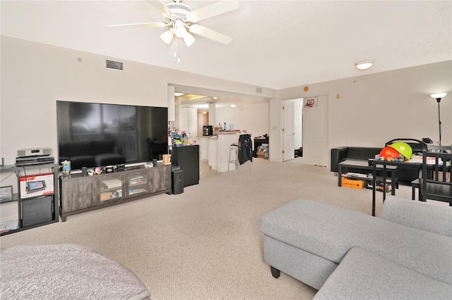 carpeted living room featuring ceiling fan