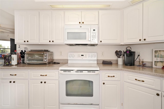 kitchen featuring white appliances and white cabinetry