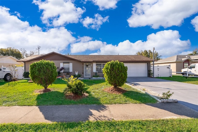 single story home featuring a garage and a front lawn