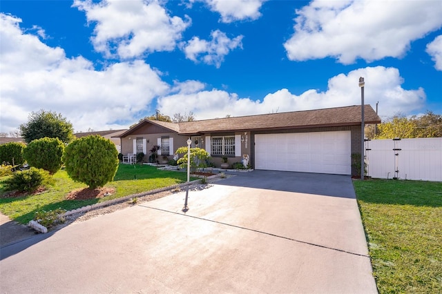 ranch-style home with a garage and a front lawn