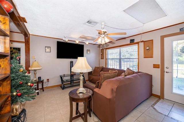 living room with ceiling fan, rail lighting, crown molding, a textured ceiling, and light tile patterned floors