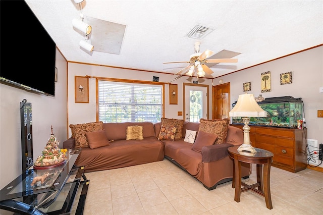 tiled living room featuring a textured ceiling, ceiling fan, and ornamental molding