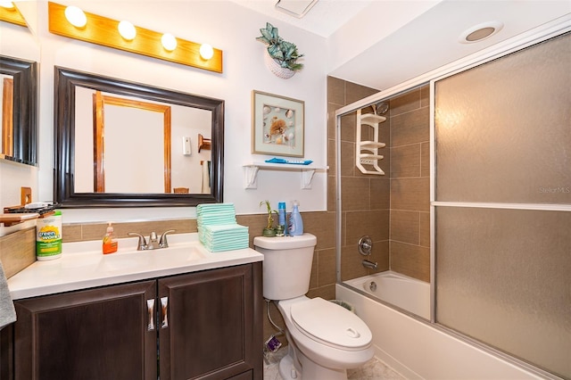 full bathroom with vanity, toilet, and enclosed tub / shower combo