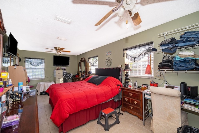 bedroom with ceiling fan and light tile patterned floors