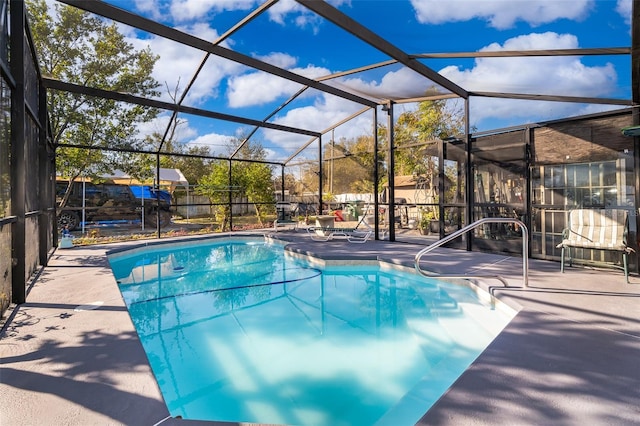 view of pool featuring a patio area and a lanai