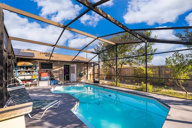 view of swimming pool with a lanai and a patio