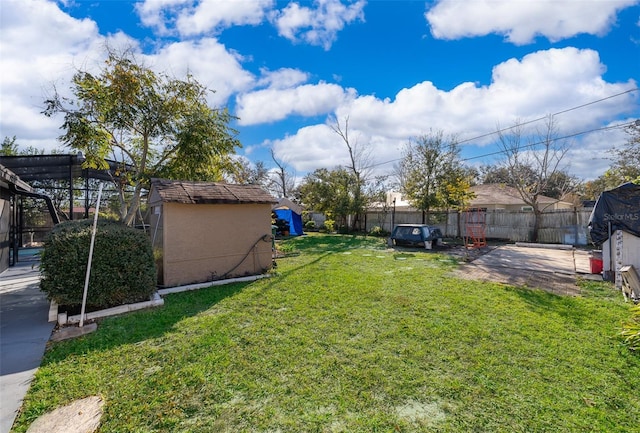 view of yard featuring a storage unit and a patio area