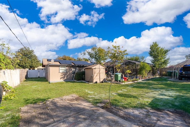 view of yard featuring a lanai and a storage unit