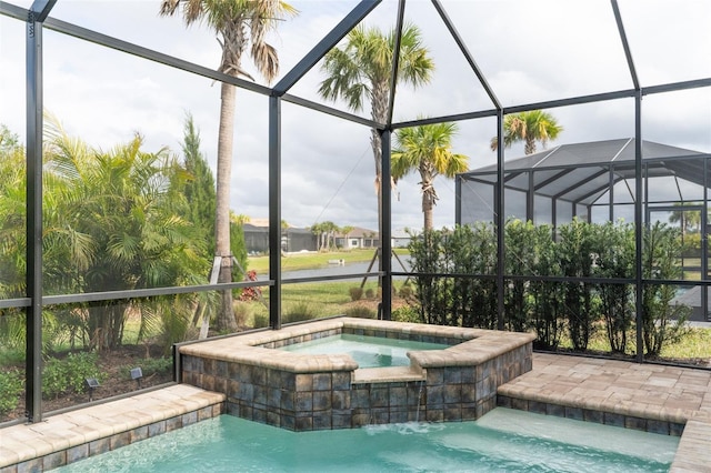 view of pool featuring an in ground hot tub and a lanai