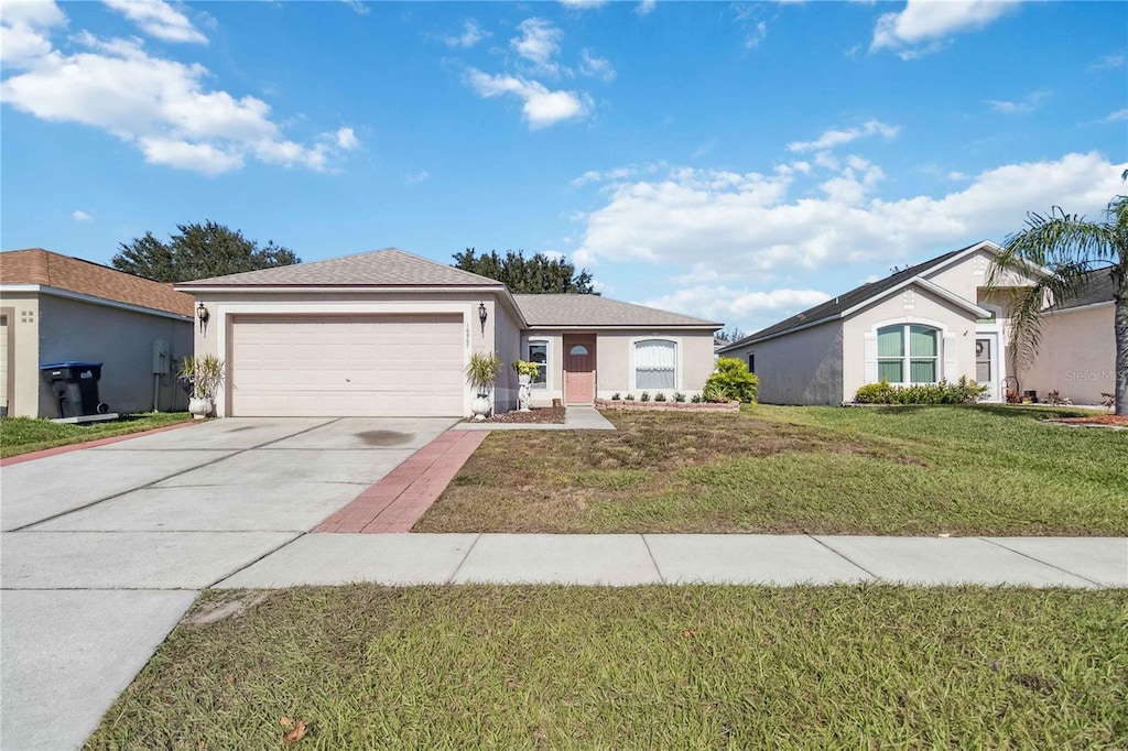 ranch-style house with a front yard and a garage