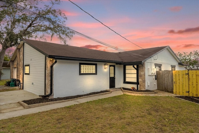 ranch-style house featuring a lawn