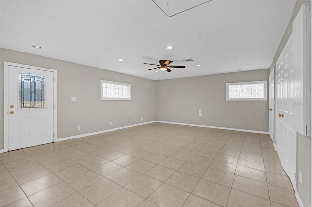 empty room featuring light tile patterned flooring, plenty of natural light, and ceiling fan