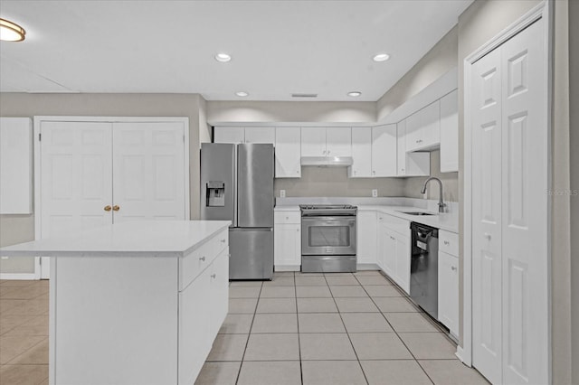 kitchen featuring white cabinetry, sink, a center island, light tile patterned floors, and appliances with stainless steel finishes