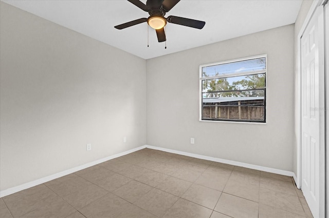 tiled empty room with ceiling fan