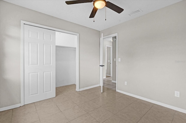 unfurnished bedroom with ceiling fan and a closet