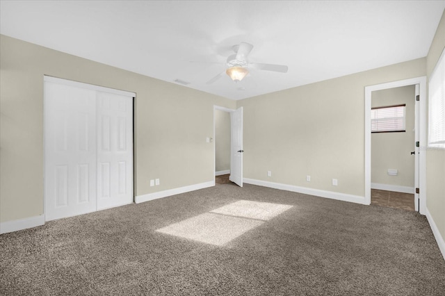 unfurnished bedroom featuring ceiling fan, carpet floors, and a closet