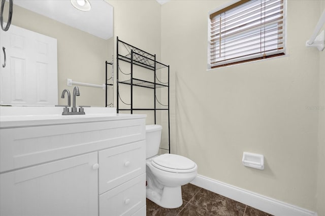 bathroom featuring tile patterned floors, vanity, and toilet