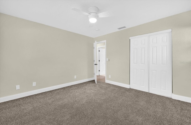 unfurnished bedroom with ceiling fan, a closet, and carpet