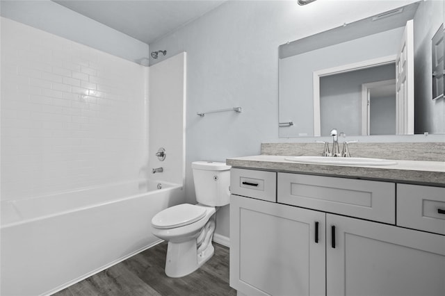 full bathroom featuring vanity, bathing tub / shower combination, hardwood / wood-style flooring, and toilet