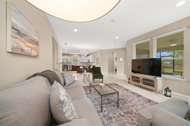 living room featuring light tile patterned floors and an inviting chandelier