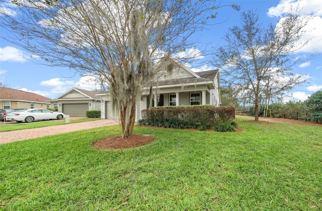 view of front of property with a front yard and a garage