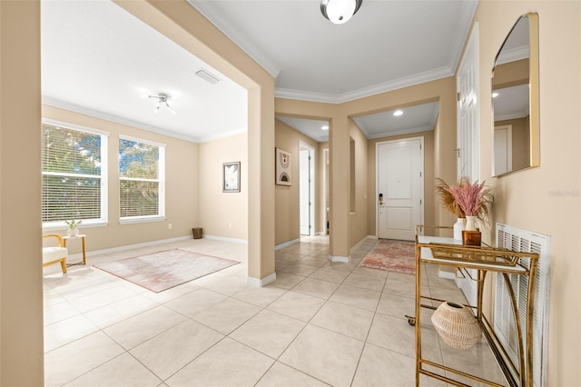 tiled foyer entrance featuring ornamental molding