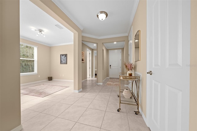 tiled foyer featuring ornamental molding