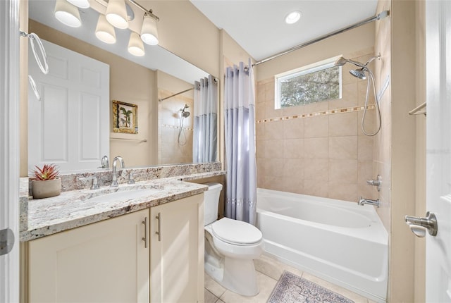 full bathroom featuring tile patterned floors, shower / tub combo with curtain, vanity, and toilet