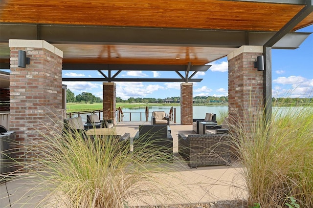 view of patio featuring a water view and a dock