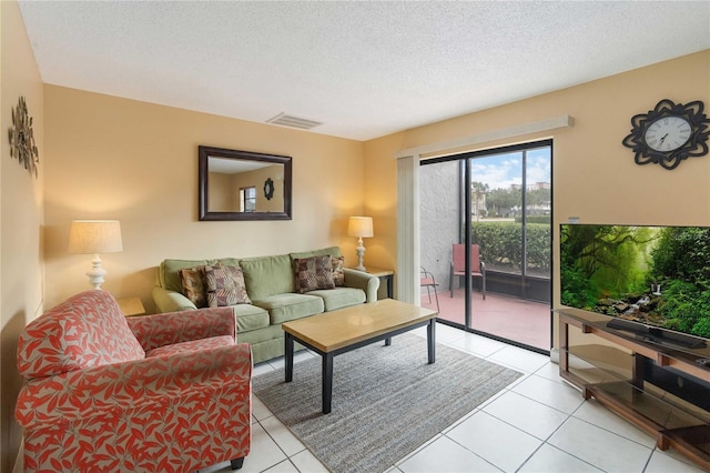 living room with light tile patterned floors and a textured ceiling